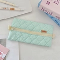 Detailed macro view of mint green quilted pencil case with textured diamond pattern - Mint Green