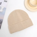 Detail of beige ribbed knit beanie texture with elegant minimalist lifestyle decor - One Size / Beige