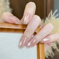 Macro shot of glossy nude pink press-on nails with a long oval shape on hand - By2373 Cat's Eye Serenity / Glue Type