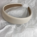 Detail showing the white lychee leather texture and brown velvet lining of the headband - Milk White