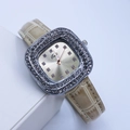Détail macro d'une montre carrée dorée de luxe avec lunette diamantée et cuir beige - Jaune Clair Boîtier Argent