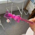 Detailed shot of pink acetate bow hair clip with pearl pendant and MYBEAR lettering - Light Rose Pink Bow