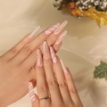 Pink and white glitter Christmas press-on nails in long coffin shape with heart patterns - Pink White Candy Cane Bow Style (JP1909)