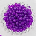 Close-up of semi-transparent purple glass beads for DIY jewelry in a glass tray - 4mm / Dark Purple