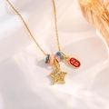Detailed shot of gold necklace with star charm, rainbow bead, and red lucky pendant - Gold Lucky Star Style