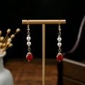 Detail of vintage beaded earrings with white pearls and red beads on a golden display stand - Red White Gold Classic Beads