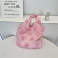 Detail of 3D rose fabric flowers on a pink canvas shoulder bag for a romantic aesthetic - Pink