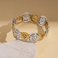 Detailed macro view of vintage stretch bracelet with gold hearts and LOVE engraving - Bracelet - Gold