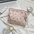 Detail of floral makeup bag with pink rose patterns on a soft fabric texture - Pink Rose Polyester