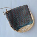 Teal and brown argyle knit neck warmer for kids on a bamboo tray with wooden decor - Lake Blue Rhombus