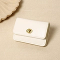 Detail view of cream vintage faux leather wallet with golden metal twist lock closure - White