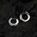 Polished silver hoop earrings with a minimalist round design on a dark textured background - White Gold