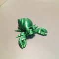 Detailed macro view of a green 3D printed hermit crab toy with visible layer textures - Hermit Crab / Silk Green