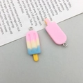 Close-up of cute resin popsicle charms in pastel gradient and pink with metal hooks - Pink Resin Ice Cream