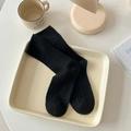Thick black wool socks with rib knit texture for women in cozy lifestyle scene - One Size / Black