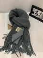 Detail of color-block scarf with fringes and logo label on white surface - Heather Grey