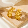 Detail of gold C-shaped earrings with unique wavy texture on a beige stone surface - Irregular Wrinkled Stud Earrings Gold (F514)