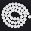 Strand of white matte round beads for DIY jewelry making displayed on black background - Frosted Porcelain White Glass / 6mm/1 Piece Approximately 63 Pieces/21g