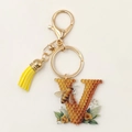 Detail of bee honeycomb letter V keychain with yellow tassel and lobster clasp - Letter V