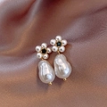 Detailed macro of Baroque pearl earrings with golden floral black gemstone accents - Baroque Style Gold Pearl Flower Black Gemstone (28#)