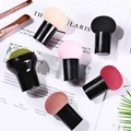 Flat lay of makeup sponges with black handles in multiple colors on a stylish magazine - Mushroom Head + Stamp