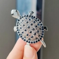 Cartoon turtle brooch pin with dark blue rhinestones and silver-colored alloy base - Silver