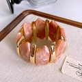 Macro shot of pink marble resin tiles and golden metal spacers on elastic bracelet - Gold Purple Marble Resin Bangle