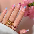 Light blue French tips with small pink flowers on long almond shaped press-on nails - Bz1402 Tricolor Flower / Jelly Glue + Nail File