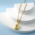 Golden bubble letter D pendant necklace with beaded chain on minimalist blue background - Letter D(D)