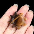 Hand-carved sun-shaped natural Tiger's Eye stone sculpture with rich brown textures - Tiger's Eye
