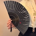 Classic Chinese folding fan with black bamboo leaf pattern and elegant hanging tassel - Weeping Willow