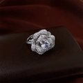 Detailed view of silver flower ring with large oval zircon on dark brown leather - White Main Stone / Silver