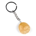 Natural yellow agate foot-shaped pendant keychain with a silver metal ring on white background - Topaz