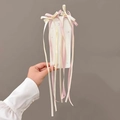 Handheld view of a pink and beige ribbon hair clip with a sweet tulip bow design - Pink Ribbon Bow Hair Clip