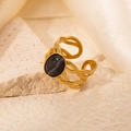 Close-up of gold stainless steel woven ring featuring an oval black gemstone inlay - Openwork Dark Grey Stone Adjustable Style (TYR0714)