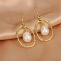 Macro shot of 18K gold-plated irregular oval earrings with teardrop freshwater pearl detail - ER1525-B Retro Hammered Ring Pearl