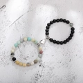 Close-up of magnetic heart clasp connecting natural stone and matte black bead bracelets - Amazonite Black Matte White K Heart