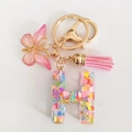 Pink glitter letter H keychain with butterfly charm and matching tassel decoration - Letter H