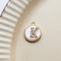 Detailed view of gold plated round shell pendant with micro-pave zircon letter K - K Round