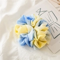 Detailed shot of a blue and yellow tie-dye chiffon scrunchie on a soft fabric background - Tie-dye Yellow Blue Ruffled Edge
