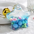 Star-shaped acrylic liquid keychain with blue sand, colorful beads and a golden bell - Bell Style / Blue