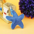 Detailed close-up of a blue starfish keychain with shiny rhinestones and a blue tassel - Lake Blue