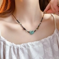 Detail of vintage beaded necklace featuring a turquoise heart pendant on a model's neck - 20# Turquoise Heart Pendant Beaded Necklace (Coffee-Green) (5650032047148)