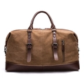 Brown canvas travel duffel bag with dark leather straps and handles on white background - Coffee