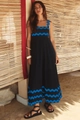 Detailed scalloped blue trim on black summer maxi dress shown in tropical outdoor setting - Black With Blue Scalloped Trim