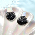 Glittering black shell resin accessories displayed in a pearlescent white tray - Black