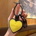 Yellow heart-shaped leather keychain featuring black stitching and rubber loop - Leather-Yellow Heart