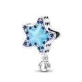 Detail of star-shaped charm with blue center, shell pendant, and sparkling zircon stones - Luminous Starfish