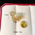 Detail view of a golden butterfly brooch with mother of pearl and crystal inlay on a display - Pearl Butterfly (C282)