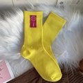 Chaussettes mi-mollet côtelées jaune vif avec écusson sourire rouge style sportif - Taille unique / Jaune